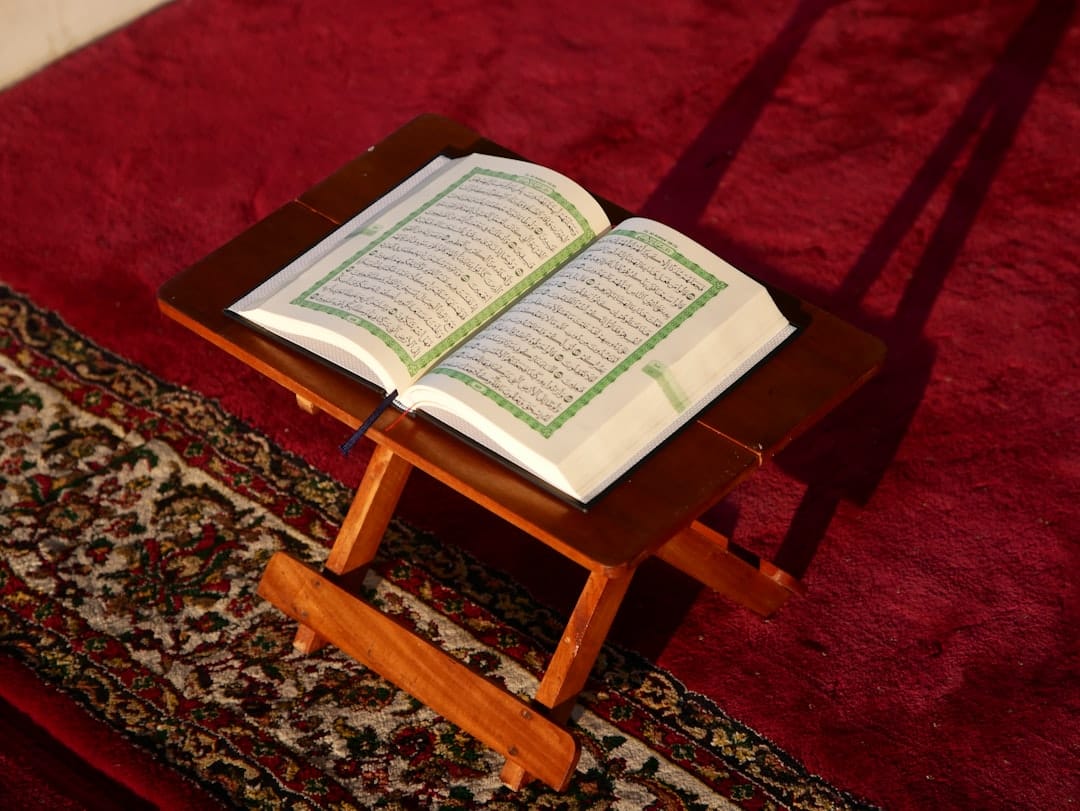 Photo by Masjid MABA an open book sitting on top of a wooden table