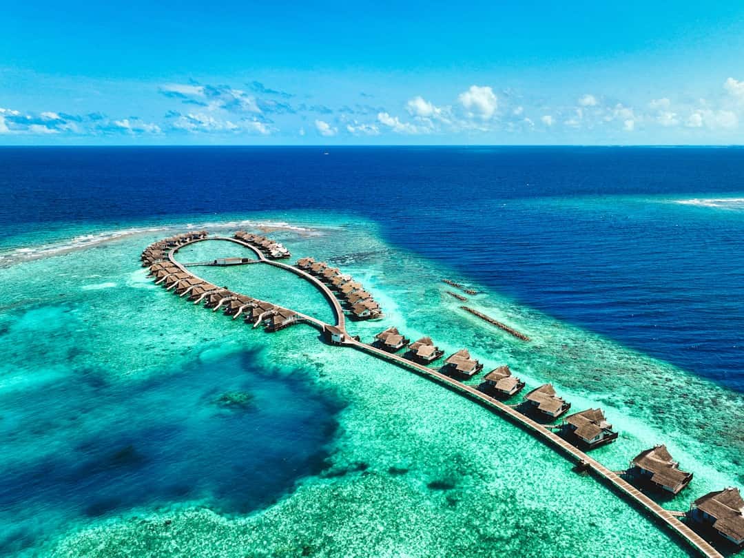 Photo by Hamdhulla Shakeeb an aerial view of a resort in the middle of the ocean