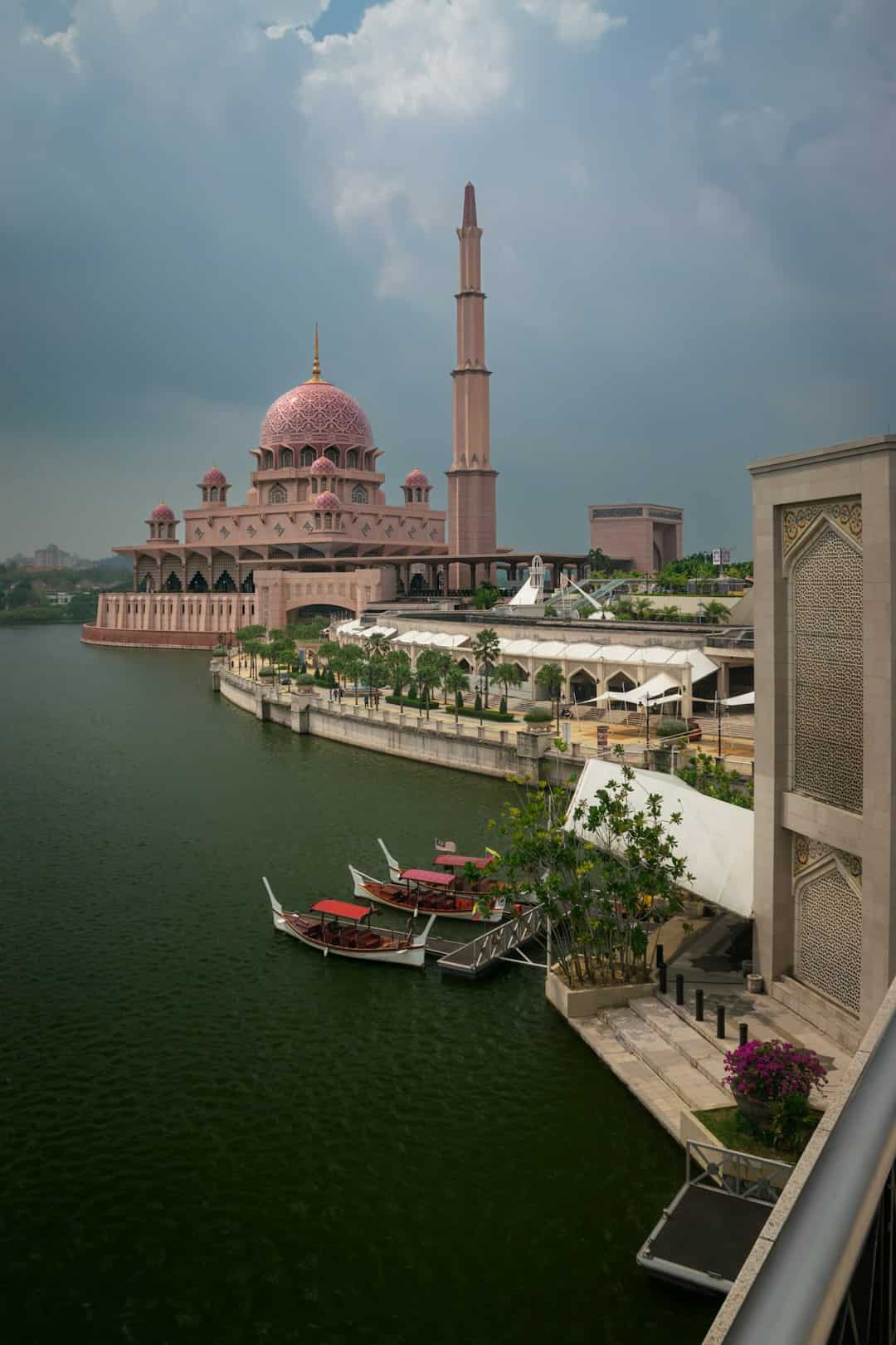Photo by Filipe Freitas a large building sitting next to a body of water